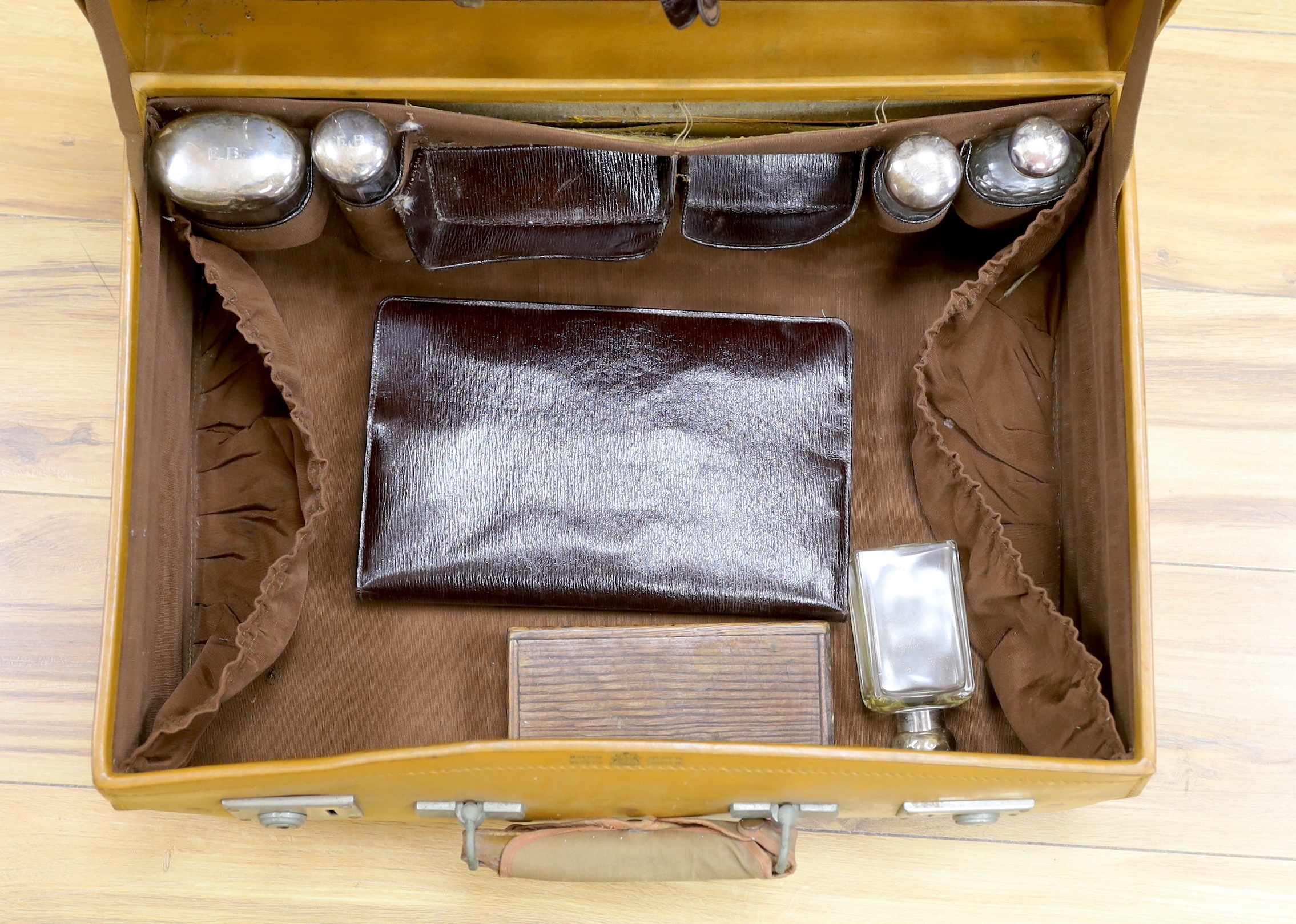 A vintage Mappin and Webb vanity case with five silver mounted bottles and shaving kit 51cm wide
